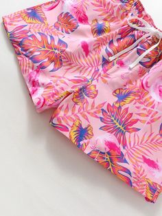 Escape to paradise with these Tropical Print Swim Trunks. The vibrant all-over print and drawstring waist make them a stylish choice for your beach adventures. Stay comfortable with the convenient pocket and non-stretch polyester fabric. Dive into summer in style! Specification: Pattern Type: Tropical, All Over Print Details: Drawstring, Pocket Type: Bottoms Bottom Type: Shorts Fabric: Non-Stretch Material: Polyester Composition: 100% Polyester Care Instructions: Machine wash, do not dry clean, Beachwear Shorts For Summer Activities, Multicolor Hawaiian Summer Bottoms, Pink Swimming Shorts For Summer, Beachwear Bottoms For Summer Activities, Short Beachwear Swimwear For Summer, Summer Swimwear With Tropical Print, Tropical Print Short Swimwear For Summer, Tropical Multicolor Shorts For Pool, Pink Shorts For Beach Party In Summer