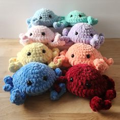 small crocheted stuffed animals sitting on top of a wooden table