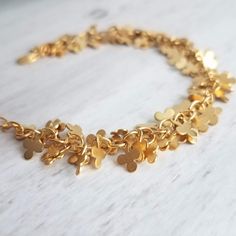 Cluster fringe of tiny matte gold finish 3-leaf clovers, finished with an adjustable chain and lobster claw clasp. 14k gold plated brass. { M e a s u r e m e n t s } Bracelet shown adjusts to fit approx 6.25 - 8 in (15 - 19.5cm). Each little clover is approx 1/4 inch {approx 6mm} tall. Please double check measurements on your own wrist prior to any purchase, if you have any doubt or concern about the fit. I'm happy to shorten the length free of charge if you leave me a note at checkout with your Fringe Bracelet, Lucky Charm Bracelet, Cluster Bracelet, S Bracelet, Good Luck Bracelet, Clover Bracelet, Cluster Bracelets, Good Luck Gifts, Snowflake Earrings