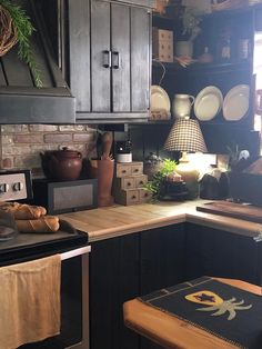 a kitchen with black cabinets and wooden counters