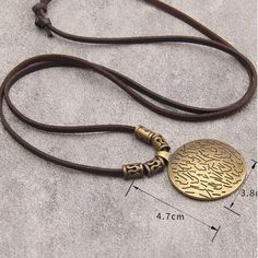 Medieval Viking round bronze pendant necklace with adjustable brown leather strap. Made from zinc alloy. Bronze Metal Fantasy Necklace, Medieval Style Metal Necklaces For Larp, Medieval Style Metal Pendant Necklaces, Bronze Symbolic Pendant Necklace, Medieval Metal Pendant Necklace, Brown Leather Strap, Bronze Pendant, Zinc Alloy, Brown Leather