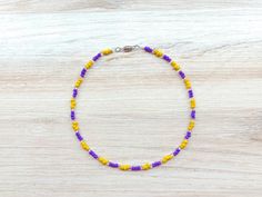 A colorful purple yellow choker necklace. This beaded choker is approx 16 inches in length. This purple women's choker is a great addition to your wardrobe. It's also a perfect gift for bridesmaid. The choker Is made with high-quality glass seed beads.  I ship my items all 5 days a week, excluding holidays. Jewelry Care Instructions: No matter what materials are involved, jewelry is delicate. You should always remove your jewelry when working with your hands or engaging in activities that involve chemicals or abrasives. Take off your jewelry before any of the following: Swimming in water that has been treated with chlorine Cleaning your home Working in the garden Playing sports, especially contact sports Don't wear a lotion with jewelry Store jewelry pieces separately Caring for your jewel Purple Choker With Colorful Beads For Gift, Purple Colorful Beads Choker Jewelry, Adjustable Purple Choker With Colorful Beads, Purple Beaded Choker With Round Beads, Purple Colorful Beaded Choker Jewelry, Yellow Tiny Beads Choker For Gift, Yellow Tiny Beads Choker As Gift, Adjustable Purple Choker With Round Beads, Adjustable Beaded Purple Choker