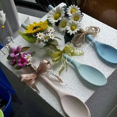 several spoons with flowers on them sitting on a table