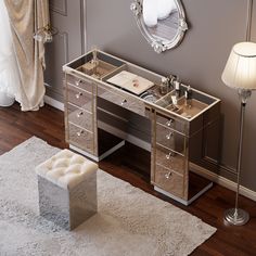 a mirrored vanity table with drawers and stool in a living room next to a white rug