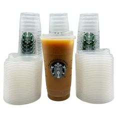 starbucks coffee cups with lids are stacked on top of each other