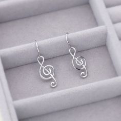 These treble clef music note dangle earrings dazzle with minimalist charm in melodious harmony. Crafted with fine 925 sterling silver, rhodium plated, nickel free. Fish hooks. Measures 1.2"(L). Get the look of celebrity inspired jewelry. Musical Note Earrings, Music Earrings, Notes Style, Fish Hooks, Treble Clef, Fish Hook Earrings, Music Note, Inspired Jewelry, Fish Hook