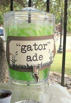 a glass jar filled with green liquid sitting on top of a metal pan next to a tree