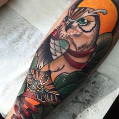 an owl and snake tattoo on the arm