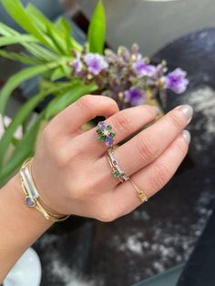 Our flora ring is as bright and vibrant as spring. Some of the rarest of all gems make up this gorgeous creation. Hand-selected tanzanites and tsavorites make this an unforgettable pairing.  The center of this ring is a beautiful vs quality diamond set to perfection in this handmade ring. Each “petal” of this ring is u Luxury Cluster Multi-stone Green Rings, Fine Jewelry Flower Ring With Accent Stones, Fine Jewelry Floral Rings With Accent Stones, Green Cluster Multi-stone Rings, Green Diamond Multi-stone Birthstone Ring, Fine Jewelry Flower-shaped Multi-stone Rings, Green Diamond Birthstone Ring With Multi-stone, Emerald Cut Tanzanite Diamond Ring, Diamond Multi-stone Flower Ring