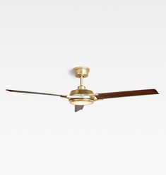 a ceiling fan with a wooden blade on it's side and a light fixture in the middle