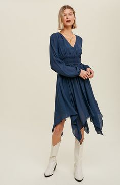 A fit-and-flare dress offers contemporary style with puffed balloon sleeves, a smocked waist, handy pockets and a flowy handkerchief hem. Slips on over head Surplice V-neck Long sleeves Partially lined 100% polyester Hand wash, dry flat Imported Model stats: 5'10" height, 32" bust, 25" waist, 36" hip. Model is wearing size Small. Billowy Solid Color Dress For Fall, Solid Billowy Dress For Fall, Billowy Fall Dress, Chic Handkerchief Hem Dresses For Fall, Chic Fall Dresses With Handkerchief Hem, Billowy Smocked Bodice Midi Dress For Fall, Chic Dress With Smocked Back And Billowy Fit, Fitted Solid Color Dress With Elastic Waistband, Fall Midi Dress With Smocked Bodice And Billowy Fit