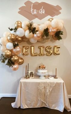 a table topped with balloons and cake next to a sign that says ellse