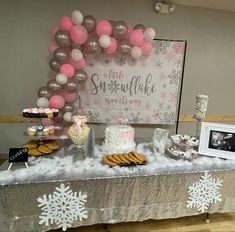 a table topped with cake and desserts next to a sign that says snowflake