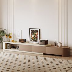 a living room with an entertainment center and vases filled with flowers on the table