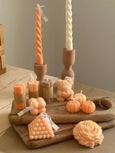 a wooden tray with candles and pumpkins sitting on it's side next to other decorative items