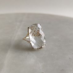 This stunning ring is set in 14k Solid Yellow Gold with Natural Clear Quartz with utmost precision. It is an unique statement gemstone ring for nearly every occasion and is completely hassle-free jewelry. ITEM DETAILS *  GEM: CLEAR QUARTZ * GEM SIZE: 12X20mm * GEM SHAPE: Cushion * Gem weight: 11.70 carats * Gold Purity: 14KT * Gold Weight: 1.53 gram * Total Weight of the Ring: 3.87 gram The Gold purity is guaranteed and it comes with authentic 14KT gold hallmark. Since my items are handmade, they are absolutely nickel and lead free. CUSTOMIZATION: * Size Customization is available for this ring and it is available in all ring sizes. Kindly choose your ideal ring size from the drop-down. * Gemstone customization is available and the it can be substituted with a gem of your choice. Kindly me Gold In Quartz Ring, Affordable Crystal Ring With Prong Setting As Gift, Quartz Engagement Ring Simple, Cheap Gold Crystal Ring With Gemstone, Luxury Timeless Crystal Ring With Prong Setting, Luxury Minimalist Formal Crystal Ring, Cheap Crystal Ring With Prong Setting As Gift, Cheap Elegant White Gold Crystal Ring, Luxury Minimalist Yellow Gold Crystal Ring