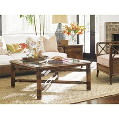 a living room filled with furniture and a fire place in the middle of the room