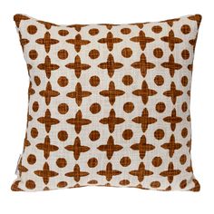 an orange and white pillow with brown circles on the front, against a white background