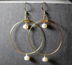 1 1/2 inch diameter gold plated hoops have this cut 7mm pearl dangling in the center and bottom.   All wires and components are gold plated.  Great quality pearl.   Chic and stylish,  also available in clip on style. Gold Hoop Earrings With Pearl Drop In Brass, Gold Brass Hoop Earrings With Pearl Drop, Gold Metal Hoop Earrings With Pearl Charm, Gold Hoop Pearl Earrings Nickel Free, Hammered Jewelry, Pearl Earrings Wedding, Dangle Hoop Earrings, Pearl And Diamond Earrings, Pearl Hoop Earrings