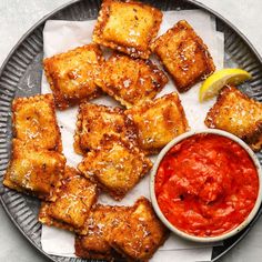 fried tofu sticks with marinara sauce and lemon wedges