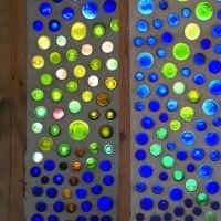 two decorative wall panels made out of glass bottle caps and plexed wood planks