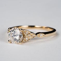 a gold engagement ring with a white diamond in the center