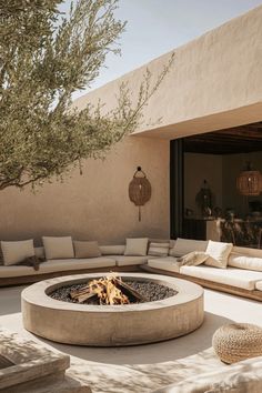 an outdoor fire pit with seating around it