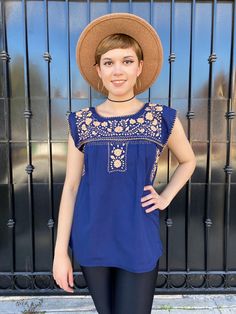 "Navy blue floral embroidered mexican blouse, cotton sleeveless blouse women, ibiza vacation, resort wear tropical destination, rodeo fashion, cinco de mayo, mexican party, fiesta san antonio, fiestasa, charro days, sombrero dest, hispanic heritage month, dia de la independencia, peasant blouse. This adorable Puebla top is perfect for summer, the bright colors and hand embroidered flowers give just the taste of Mexico and summer combined. Rare to find It is definitely the Traditional Mexican top Sleeveless Embroidered Summer Beach Top, Bohemian Sleeveless Embroidered Top For Summer, Bohemian Embroidered Top For Vacation, Bohemian Embroidered Summer Top, Bohemian Embroidered Top For Summer, Bohemian Sleeveless Top With Floral Embroidery, Sleeveless Floral Embroidery Vacation Blouse, Summer Embroidered Top With Floral Design For Vacation, Summer Floral Embroidered Top For Vacation