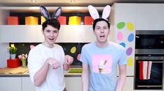 two young men in bunny ears standing next to each other