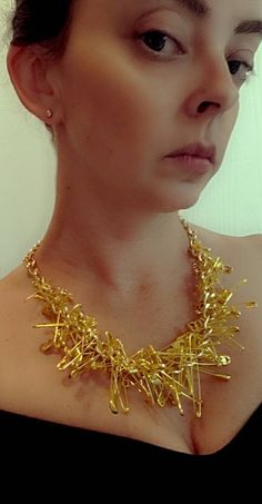 "Gold colored chain measuring about 21\" long has been adorned with tons of golden safety pins.   Pins of many different sizes scattered about the chain makes this necklace quite funky!  Rihanna is pictured wearing one just like it.  Handmade.  NOTE: Photo is a sample, actual item will vary slightly To continue shopping: http://www.rrrobinnn.etsy.com" Gold Accessories Outfit, Staff Wellbeing, Mens Pearl Necklace, Safety Pin Necklace, Chain Clothes, Pin Necklace, Grunge Accessories, Dark Autumn, Hand Necklace