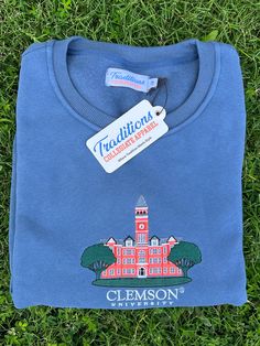 Show your school spirit in this super soft cotton-polyester blend sweatshirt. The tight, clean embroidery on the chest pops with the iconic campus building logo. The ribbed collar, cuffs, and hem add structure and style to this cozy crewneck top. Whether heading to an early morning class or late night game, this sweatshirt allows you to display your college pride in casual comfort. The durable fabric ensures this classic embroidered college sweatshirt will remain a staple in your rotation for years. Collegiate College Tops With Embroidered Logo, Collegiate Tops With Embroidered Logo For College, Collegiate Sweatshirt With Embroidered Graphics, Spring Campus Cotton Sweatshirt, Collegiate Cotton Sweatshirt For Campus, Collegiate Tops With Embroidered Graphics For College, Collegiate Spring Sweatshirt With Ribbed Cuffs, Collegiate Cotton Sweatshirt For Spring, Collegiate Style Sweatshirt With Ribbed Cuffs For Spring