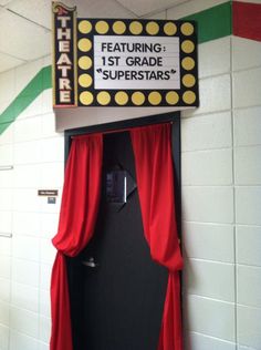 a door with red curtains and a sign above it that says,'the theatre '