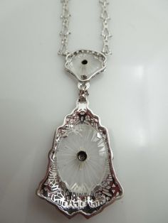 "For Sale: (1) g610 Elegant Ladies 14kt White Gold Diamond Filigree Necklace Pendant PLEASE READ ENTIRE DESCRIPTION BEFORE PURCHASING This is a stunning piece. Set in 14kt white gold, this camphor piece comes attached to the long and short style chain. Centered in the bigger part of the pendant, is a .02ct old mine cut diamond. Perfect for that special occasion. Would be a nice birthday, anniversary, Mother's Day or Valentine's Day gift for her! Specifics: 14kt White Gold Camphor Glass Diamond w Exquisite Hallmarked Diamond Necklace For Formal Occasions, Antique Round Necklace With Diamond Accents, Antique White Gold Pendant Necklace, Evening Platinum Necklace With Diamond Cut, Evening Platinum Diamond Cut Necklace, Platinum Diamond Cut Necklace For Evening, Antique White Gold Diamond Pendant Necklace, Formal Hallmarked Pendant Diamond Necklace, Antique Diamond Pendant Necklace For Formal Occasions