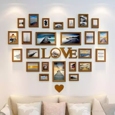 a living room filled with furniture and framed pictures on the wall above a love sign