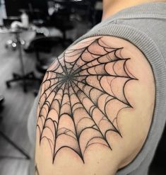 a man with a spider web tattoo on his arm