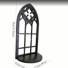 a black metal shelf with an intricate design on the top and bottom, along with measurements for