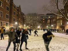 many people are playing in the snow at night