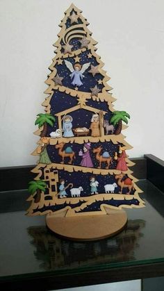 a wooden christmas tree with nativity scene on it