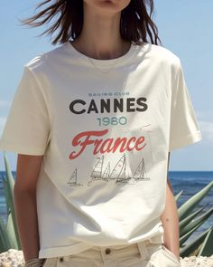 More styles in our SHOP: thepalmsclubla.etsy.com Set sail in style with our vintage-inspired Cannes France Sailing Club T-Shirt! 🌊⛵ This trendy graphic tee captures the timeless allure of coastal France, making it a perfect addition to any wardrobe. 👕 Made of 100% high-quality soft cotton, our unisex t-shirt offers both comfort and durability, ensuring you can enjoy your adventures without compromising on comfort. The front features a classic 1980 Cannes France art, complete with elegant sailboats and the iconic club emblem. The minimalist yet sophisticated design makes it an ideal piece for those who appreciate a nautical aesthetic. 🛥️🇫🇷 Whether you're out on the deck or exploring the city streets, this tee is versatile enough to match any occasion. It's a perfect gift for the sailin Etsy Tee Shirts, Saint Tropez France, Cowgirl Graphic, St Tropez France, Nautical Aesthetic, Coastal Summer, San Tropez, Summer Graphic Tee, Club T Shirt