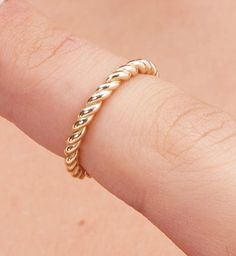 Elevate your style with our exquisite Gold Twist Ring, a true masterpiece of artisan craftsmanship. This stunning piece is meticulously handcrafted to add a touch of luxury and sophistication to your everyday or special occasion look. 🌟 Key Features 🌟 🔸 Material: 14K Gold 🔸 Design: Unique Twist Pattern 🌟 Product Details 🌟 Our Gold Twist Ring is expertly fashioned from high-quality 14K gold, ensuring long-lasting beauty and durability. The unique twist pattern of this ring adds a captivating element to your ensemble, making it a conversation starter and a treasured addition to your jewelry collection. 🌟 Versatile Elegance 🌟 This ring's timeless design allows it to effortlessly transition from day to night, making it the perfect accessory for any occasion. Whether you're dressing up Handmade Gold Round Band Jewelry, Handmade Gold Jewelry With Round Band, Luxury Stackable Bands As A Gift, Luxury Stackable Bands For Gift, Luxury Stackable Bands As Gift, Classic Jewelry With Diamond Cut And Thick Band, Luxury 14k Gold Stackable Rings Gift, Elegant Yellow Gold Bands As Gift, Handmade Timeless Jewelry For Wedding