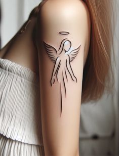 a woman's arm with an angel tattoo on the back of her shoulder,