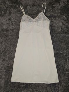 Light up your nights with this lovely form-fitting sleek feel nylon full slip from Lorraine. This is of 1960's style, with intricate lacework on the bust and bottom to bring out the flower in you! The official size on the tag is a women's size 36. Condition: Minor signs of wear. Fitted Delicate Lace Nightgown For Sleep, Lace Fitted Slip For Sleep, Fitted Lace Slip For Sleep, Sheer Fitted Slip With Spaghetti Straps, Fitted Sheer Lace Nightgown, Sheer Fitted Camisole Slip, Fitted Lace Nightgown With Built-in Bra, Fitted Sheer Camisole Slip, Fitted Lace Trim Camisole For Wedding Night