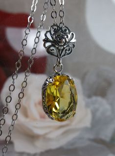 Yellow Citrine Pendant (Choose Simulated or Natural gemstone) Edward Design #P70 Custom Made This is a lovely Edwardian reproduction pendant in sterling silver filigree with a beautiful yellow citrine stone (Choose between a Simulated or a Natural Gemstone). This gem is 14mm x 10mm and is approximately 4.5ctw. The pendant is 27mm x 11mm. The sterling silver chain (if chosen) is adjustable between 18-20". The necklace & chain are marked 925 for sterling silver. The beautiful leaf design of the si Oval Yellow Jewelry As Gift, Yellow Oval Faceted Jewelry, Edwardian Design, Edwardian Necklace, Victorian Filigree, Yellow Pendant, Filigree Pendant Necklace, Filigree Necklaces, Filigree Jewelry