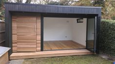 an outdoor room with sliding glass doors on the outside and wood flooring in the inside