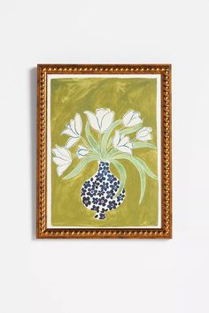 a painting with white flowers in a blue vase on a green background and gold frame