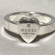 Crafted From 925 Sterling Silver, This Timeless Piece Features A Heart Detail That Defines The Love Ring. Reflecting Gucci's Romantic Narrative, The Ring Is Further Enhanced By The Gucci Trademark. This Luxury Accessory Is Perfect For Any Occasion, Blending Elegance & Style! : Stunning 925 Sterling Silver Width: 0.15" Inch () Women’s Us Size: 6 Made In Italy This Ring Embodies Gucci’s Commitment To Social & Environmental Responsibility, Ensuring Sustainable Craftsmanship. Bundle With Another Ite Ring With Heart, Gucci Jewelry, Elegance Style, Love Ring, Luxury Accessories, Womens Jewelry Rings, Elegant Fashion, Solid 925 Sterling Silver, A Heart