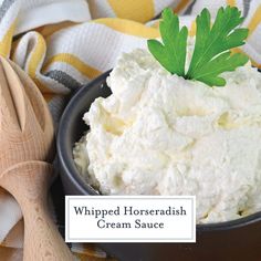 whipped horseradh cream sauce in a black bowl with parsley on the side