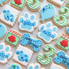 decorated cookies are displayed on a table