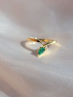 Simple dainty 14k Solid Gold ring pointed angle with a pear shaped  emerald stone and a small natural round diamond great condition size 5.5 2.5 grams Gold Teardrop Emerald Promise Ring, Elegant 14k Gold Teardrop Emerald Ring, Green Teardrop 14k Gold Ring, Yellow Gold Teardrop May Birthstone Ring, Yellow Gold Teardrop Ring For May Birthstone, Elegant Teardrop Emerald Ring In 14k Gold, Green Pear-shaped 14k Gold Rings, Yellow Gold Teardrop Emerald Ring For Anniversary, 14k Gold Pear-shaped Emerald Ring