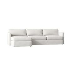 a white couch sitting on top of a white floor